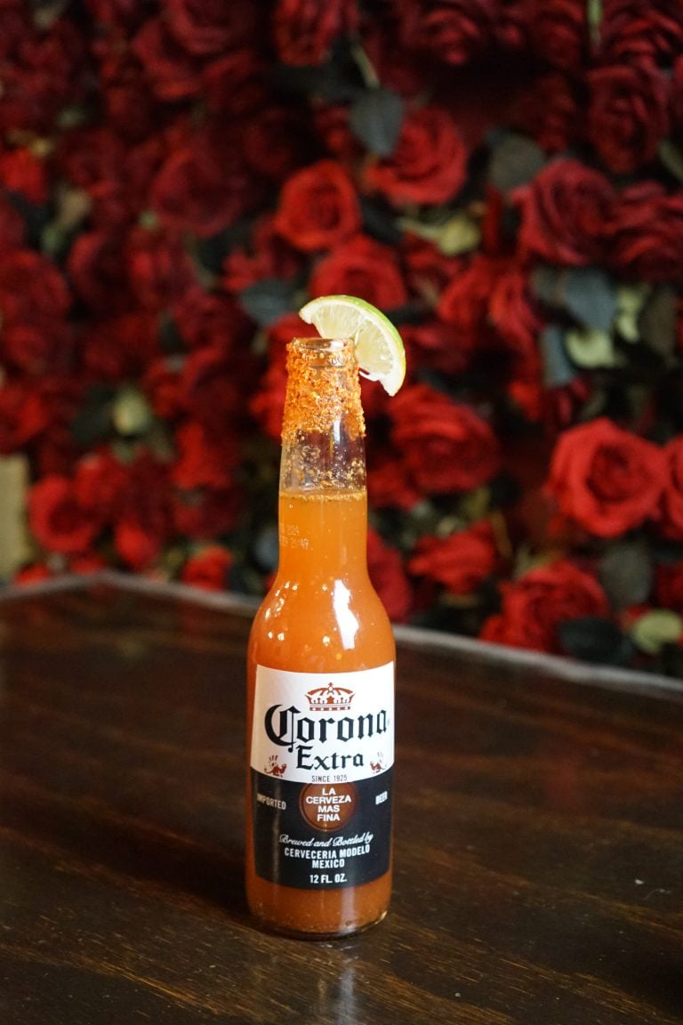 a bottle of beer with a lime on top