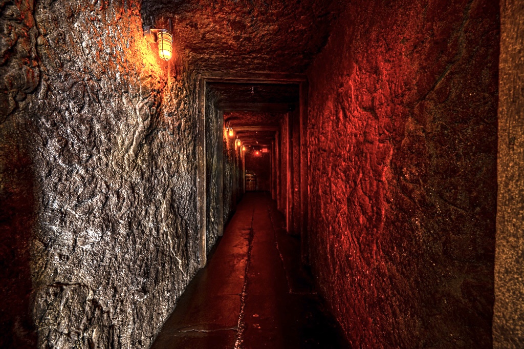 Dimly lit underground tunnel leading to a hidden lounge for carnitas tacos in Las Vegas
