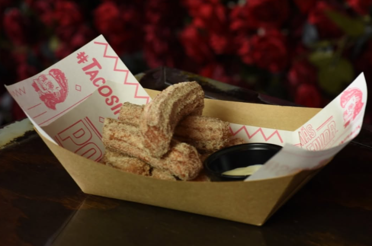 Chupa Mi Churro dessert by Más Por Favor in Las Vegas featuring golden, cinnamon-sugar coated cream cheese churros served with dipping sauce.