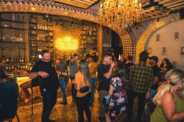 Lively interior of Más Por Favor’s hidden speakeasy in Las Vegas, a popular hangout for guests enjoying tacos, cocktails, and their favorite queso dip in the city.