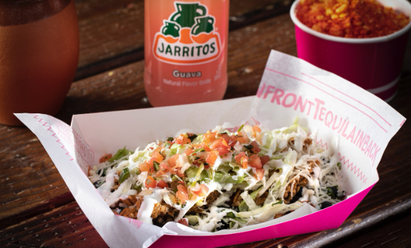 Street-style loaded taco salad from Mas Por Favor in Las Vegas with pico, crema, and fresh toppings — a local favorite for anyone searching for the best taco-inspired salads around town.